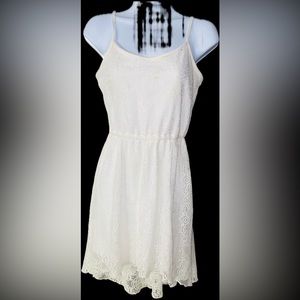 Bailey Blue, white spaghetti strap dress with lace over layer.